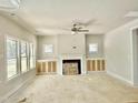 Spacious living room with a ceiling fan, a fireplace, and built-in cabinets at 1803 Ballard Rd # Holly Craftsman, Fuquay Varina, NC 27526