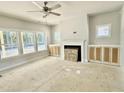 Bright living room featuring large windows, a fireplace, and built-in cabinets at 1803 Ballard Rd # Holly Craftsman, Fuquay Varina, NC 27526