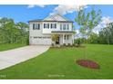 Two-story home featuring a light-brick facade, attached two-car garage, and a spacious green lawn at 1849 Ballard Rd # Holly Georgian, Fuquay Varina, NC 27526