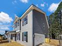 Two-story home featuring gray brick, siding, black shutters, and an attached garage at 1849 Ballard Rd # Holly Georgian, Fuquay Varina, NC 27526