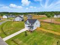 Beautiful aerial view of a modern home surrounded by a lush green lawn in a peaceful neighborhood at 22 Whistling Way # 18, Lillington, NC 27546