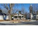 Charming house with inviting front porch nestled among mature trees, exudes warmth and neighborhood appeal at 306 S Driver St, Durham, NC 27703