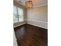 Bright dining area featuring modern lighting, stylish table, and large window overlooking the outdoors at 3144 La Costa Way, Raleigh, NC 27610