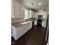 Well-equipped kitchen with white cabinets, sleek countertops, and modern black appliances at 3144 La Costa Way, Raleigh, NC 27610