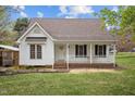 Attractive single-Gathering home featuring a front porch with white railing and blue shutters at 3738 Lindsey Woods Rd, Hillsborough, NC 27278