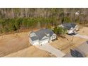 An elevated view of the house showing the roofline, expansive yard and proximity to the surrounding wooded areas at 40 Cinnamon Teal Way, Youngsville, NC 27596