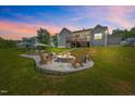 Outdoor space featuring a stone fire pit and comfortable seating, perfect for entertaining at 40 Cinnamon Teal Way, Youngsville, NC 27596