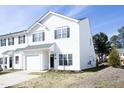 Charming two-story townhouse with white siding, black shutters, and an attached one car garage at 407 Misty Grove Cir, Morrisville, NC 27560