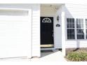 A close up view of the front door including the address, 407, with sidelight windows and door hardware at 407 Misty Grove Cir, Morrisville, NC 27560