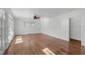 Bright living room with hardwood floors, paneled walls and natural light from the window at 413 Hocutt Rd, Durham, NC 27703