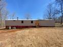 Exterior view of single-story home featuring horizontal siding and red window shutters at 415 Island Creek Estates Rd, Henderson, NC 27537