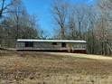 Exterior view of single-story home featuring horizontal siding and red window shutters at 415 Island Creek Estates Rd, Henderson, NC 27537