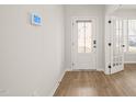 Bright foyer with hardwood floors and access to a study featuring glass French doors at 474 W Ravano Dr, Clayton, NC 27527
