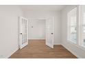 A light-filled study with hardwood floors, and white French doors at 474 W Ravano Dr, Clayton, NC 27527
