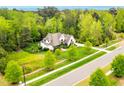 Spacious home with fenced yard surrounded by lush greenery, mature trees, and a well-manicured lawn at 5040 Shakori Trl, Chapel Hill, NC 27707