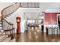 Stunning foyer with a curved staircase, hardwood floors, and an open view to the spacious living area at 5040 Shakori Trl, Chapel Hill, NC 27707