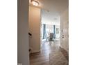 Inviting entryway with hardwood floors leading to a dining area with chandelier lighting at 505 Marthas View Way, Wake Forest, NC 27587