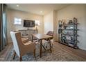 Well-lit home office with a wooden desk, comfortable seating, and stylish shelving at 505 Marthas View Way, Wake Forest, NC 27587