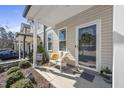 Inviting front porch with seating area and decorative accents, adding a touch of warmth and curb appeal at 510 Mariah Towns Way, Garner, NC 27529
