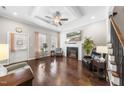 Elegant living room featuring hardwood floors, a cozy fireplace, and stylish decor at 510 Mariah Towns Way, Garner, NC 27529
