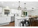 Bright kitchen with island, stainless steel appliances, and modern pendant lighting at 5613 Ashton Dr, Raleigh, NC 27612