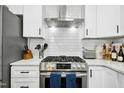 Modern kitchen features stainless steel oven and range hood at 5613 Ashton Dr, Raleigh, NC 27612