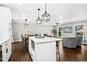 Open concept living area with kitchen island, dining table and sectional sofa at 5613 Ashton Dr, Raleigh, NC 27612