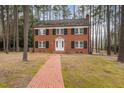 Classic two-story brick home featuring black shutters and a brick walkway at 636 Palmer Dr, Sanford, NC 27330