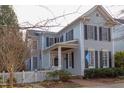 Beautiful two story home with a white picket fence, inviting front porch, and mature landscaping at 705 Highgrove Dr, Chapel Hill, NC 27516