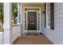 Welcoming front porch with a black front door, classic hardware, and ample natural light at 705 Highgrove Dr, Chapel Hill, NC 27516