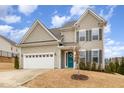 Charming two-story home featuring neutral siding, gray shutters, and a well-manicured front yard at 708 Pitchback Mill Ct Ct, Wake Forest, NC 27587