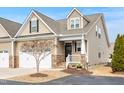 Inviting home exterior with a front porch and a well-manicured lawn at 80 Radcliffe Ct, Clayton, NC 27527