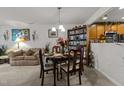 Dining room features chandelier lighting, table set for four, and adjacent living room space at 8520 Quarton Dr, Raleigh, NC 27616