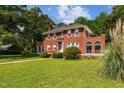 Charming red brick two-story home with meticulously maintained lawn and mature landscaping at 1000 S 9Th St, Lillington, NC 27546