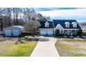 Charming home featuring an attached two-car garage, detached garage, and a spacious driveway at 105 Glasgow Dr, Clayton, NC 27520