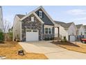A charming home boasts a one-car garage, a concrete driveway, and manicured landscaping in a suburban neighborhood at 1215 White Flint Cir, Durham, NC 27703