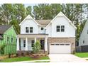Stunning two-story home with white siding, brick accents, and a welcoming front porch at 122 Sanderway Dr, Chapel Hill, NC 27516