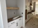 Kitchen with white cabinets, black hardware, open shelf area, light countertop, and clean design at 122 Sanderway Dr, Chapel Hill, NC 27516