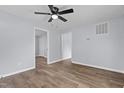 Comfortable bedroom with light-blue walls, wood-look flooring, and ceiling fan at 128 Warren Ave, Oxford, NC 27565