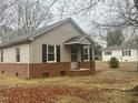 Quaint single-story home featuring a brick foundation and a covered entryway at 128 Warren Ave, Oxford, NC 27565
