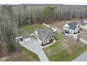 An aerial view of a lovely property with a white picket fence and an expansive manicured lawn at 1320 Blue Heron Dr, Nashville, NC 27856