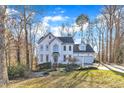 Traditional two-story home with an attached two-car garage and a well-maintained lawn at 14 Wedgewood Pl, Clayton, NC 27527