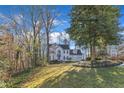 Spacious two-story home with an attached two-car garage surrounded by lush greenery and trees at 14 Wedgewood Pl, Clayton, NC 27527