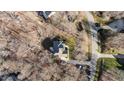 An aerial view of the home and its surrounding landscaped lot, with a long driveway, in a residential area at 155 Georgetown Woods Dr, Youngsville, NC 27596