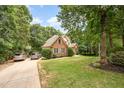 Two cars are parked in the driveway of this lovely brick two story home at 155 Georgetown Woods Dr, Youngsville, NC 27596