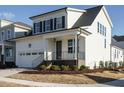 Attractive two-story home featuring white siding, black shutters, and manicured landscaping at 1800 Bright Lantern Way, Wendell, NC 27591