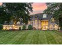 Expansive lawn leads up to this attractive stone home with meticulously maintained landscaping at 1801 Oatlands Ct, Wake Forest, NC 27587