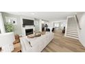 Bright and airy living room featuring hardwood floors, fireplace, and open concept design at 1903 Plott Balsam Dr, Wendell, NC 27591