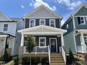 Charming two-story home features a welcoming front porch and a modern blue door at 1903 Plott Balsam Dr, Wendell, NC 27591