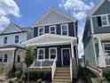 Charming two-story home featuring a welcoming front porch, craftsman details, and a beautifully landscaped yard at 1903 Plott Balsam Dr, Wendell, NC 27591